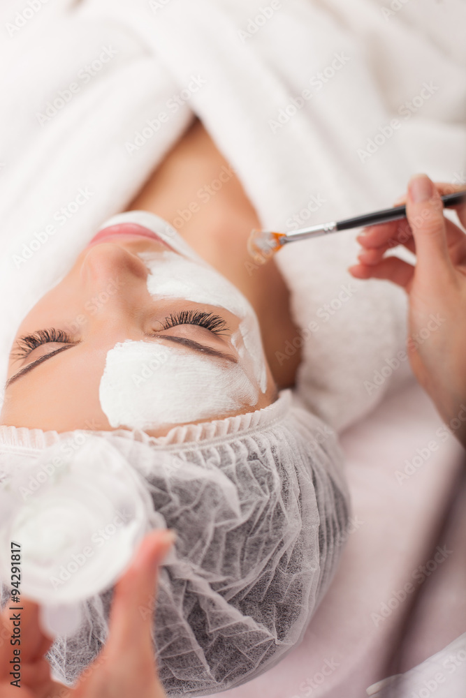 Skillful cosmetician is serving her female customer Skillful cosmetician is serving her female customer