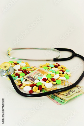 Tablets, medicines arranged in the form of heart with a stethoscope and banknotes
