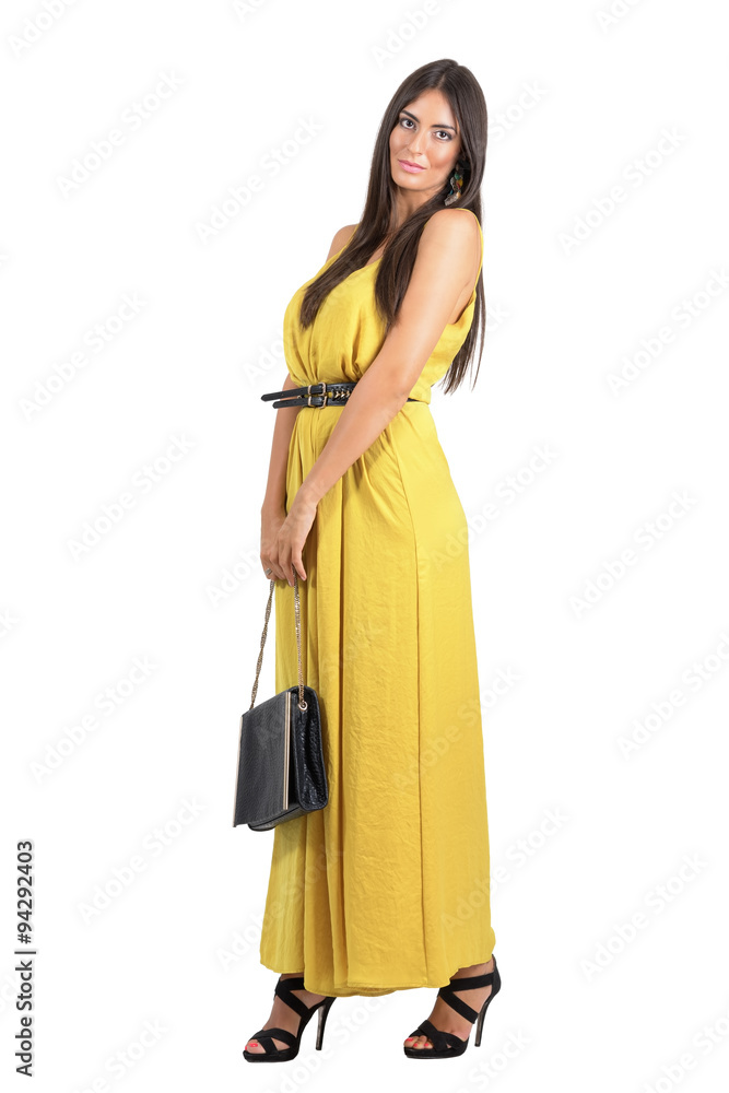 Gorgeous beauty in yellow dress with black leather handbag isolated Gorgeous beauty in yellow dress with black leather handbag isolated