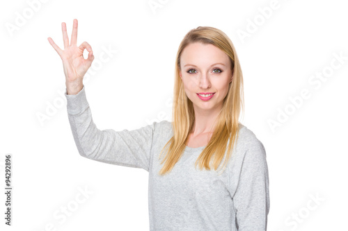 Caucasian young woman with ok sign geature
