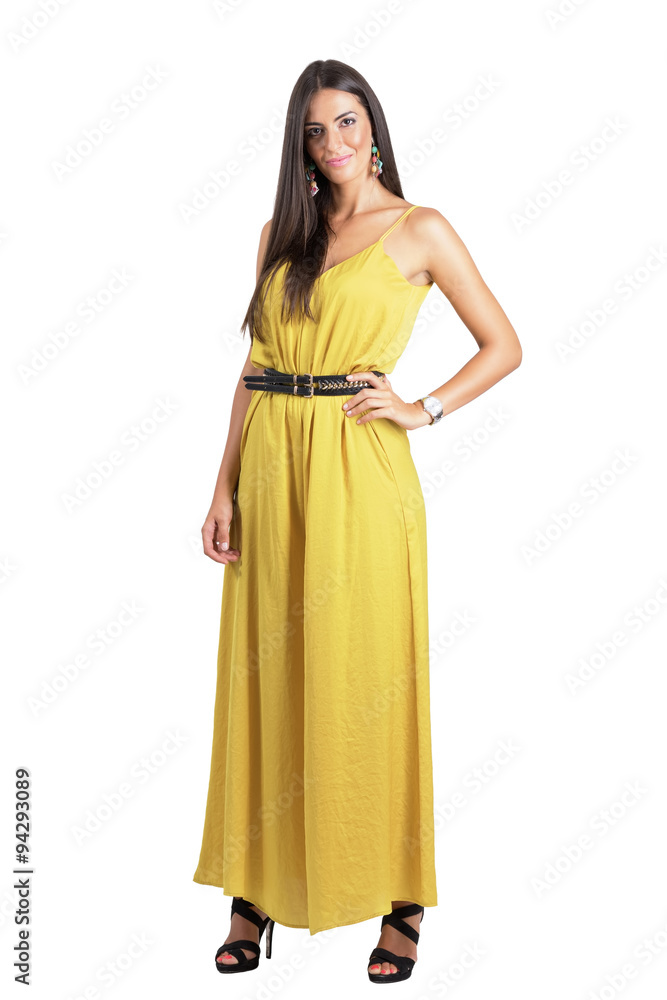 Attractive sensual beauty in ocher jumpsuit looking at camera isolated