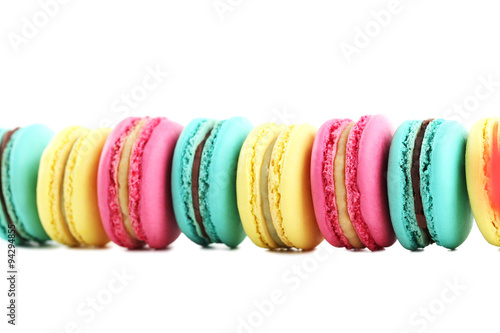 Tasty colorful macarons on white background