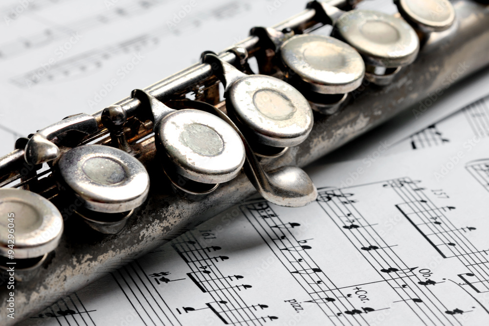 Old rusty silver flute on music notes Stock Photo | Adobe Stock
