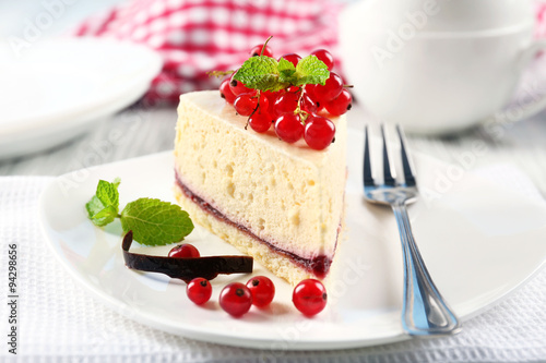 Delicious cheesecake with berries on table close up