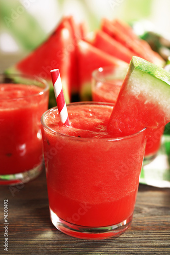Glasses of watermelon juice on wooden table, closeup
