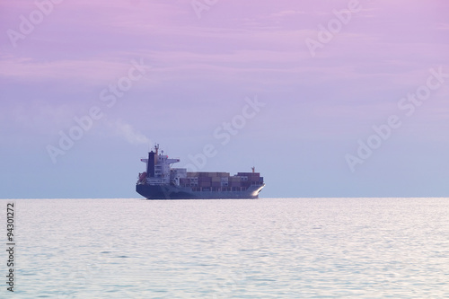 The image of a cargo ship in a open sea