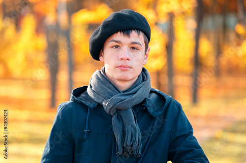 Serious teenage boy in the autumn sunny park © Kavalenkava