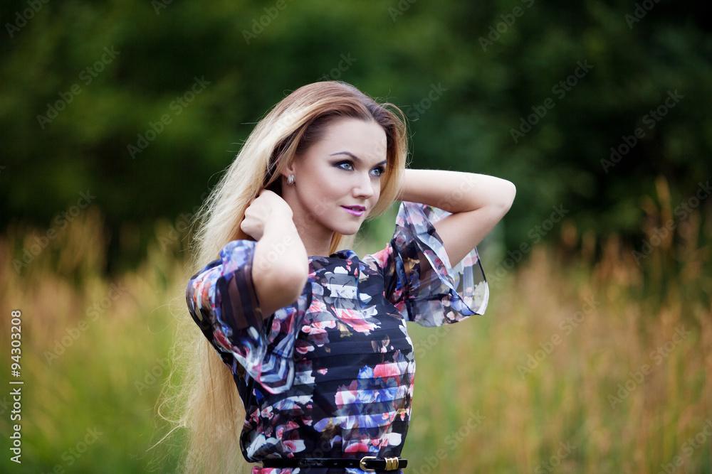 Beauty Girl Outdoors enjoying nature, blond girl in dress  on