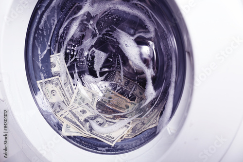 Laundering of money in washing machine, close up © Africa Studio