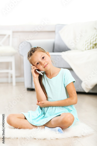 Little cute girl with mobil...