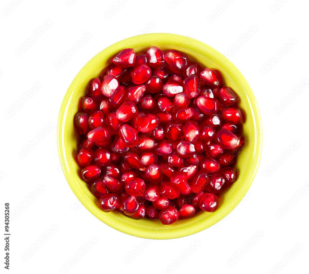 pomegranate seeds in a bowl isolated on white pomegranate seeds in a bowl isolated on white