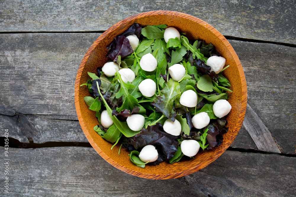 fresh green salad mix in a wooden bowl fresh green salad mix in a wooden bowl