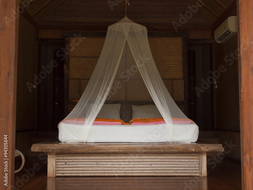 Tropical bed with mosquito netting