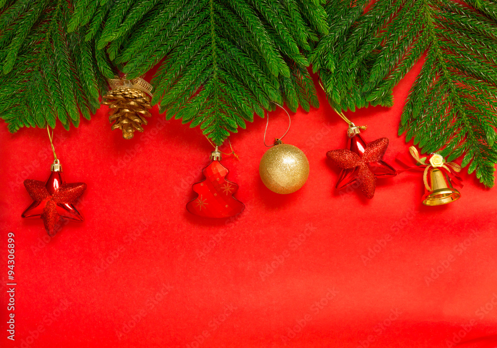 Christmas tree brach and christmas decoration on red background,