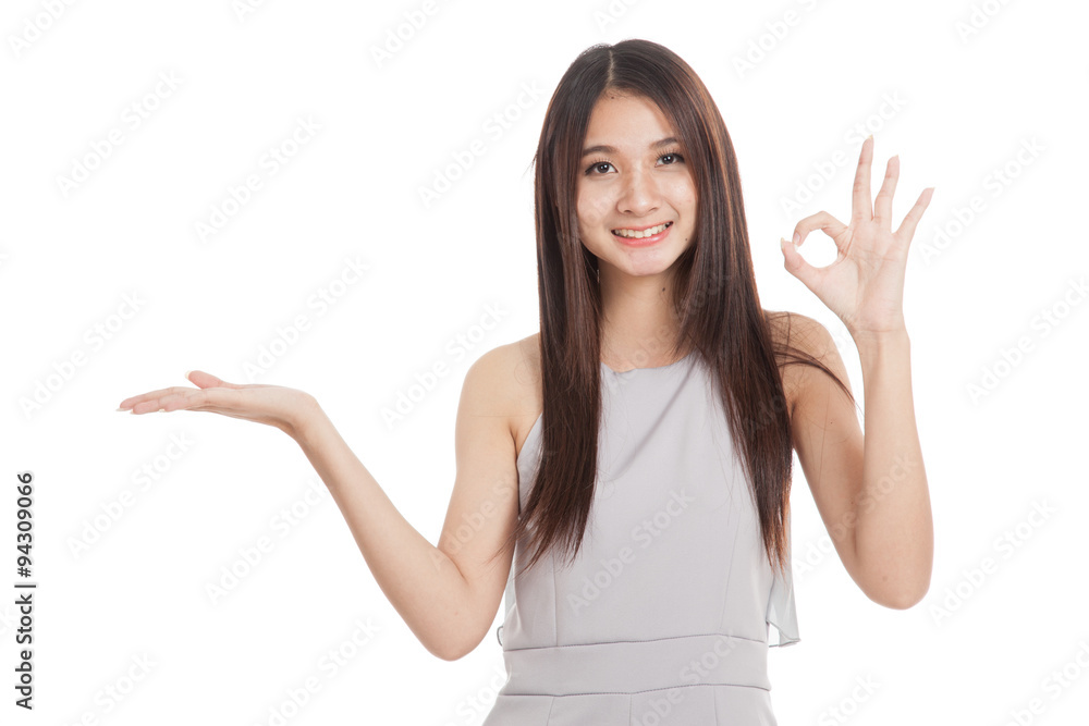 Beautiful young Asian woman show palm hand and OK sign Beautiful young Asian woman show palm hand and OK sign