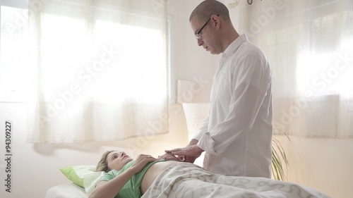 Patient And Doctor During Acupuncture Treatment in Clinic photo