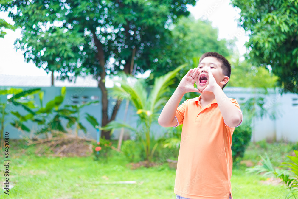 Portrait of Asian child yelling, screaming, shouting, hand on hi Portrait of Asian child yelling, screaming, shouting, hand on hi