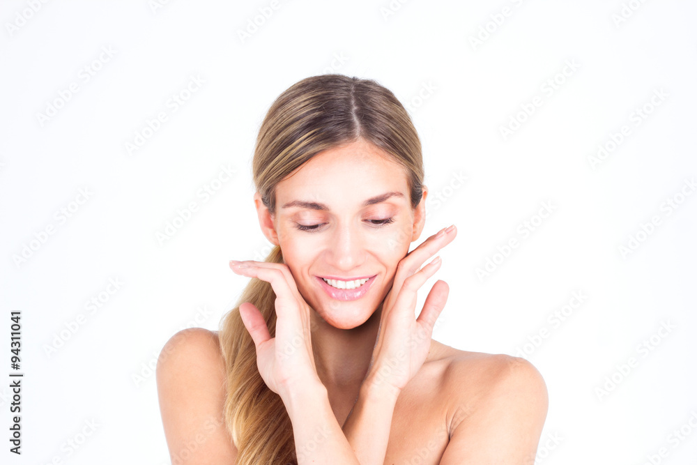 Spa & Beauty. Beautiful and clean face of woman. Beautiful woman touching her face with both hands and looking down Spa & Beauty. Beautiful and clean face of woman. Beautiful woman touching her face with both hands and looking down