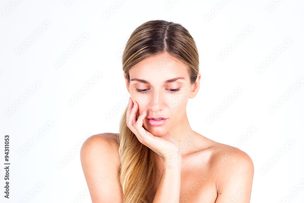 Spa & Beauty. Beautiful woman touching her face by hand and looking down Spa & Beauty. Beautiful woman touching her face by hand and looking down