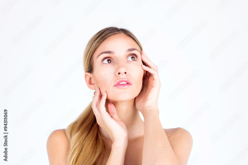 Clear skin. Beautiful woman looking up and touching face with her hands Clear skin. Beautiful woman looking up and touching face with her hands
