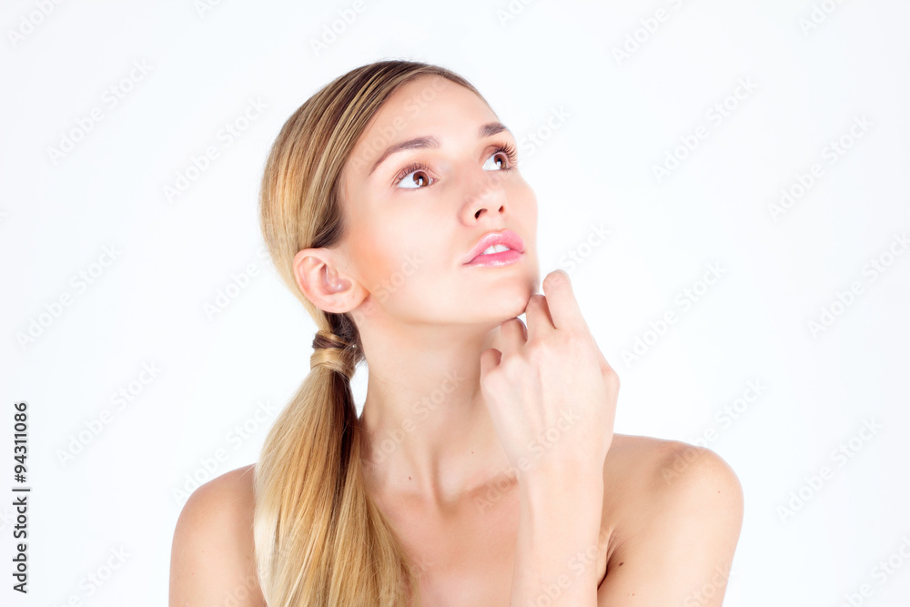 Clear skin. Beautiful woman looking up and touching face with her hands Clear skin. Beautiful woman looking up and touching face with her hands