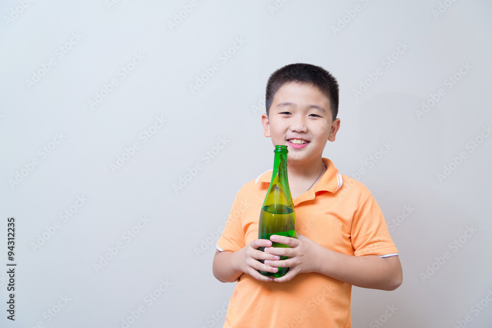 Asian boy drinking water from green bottle Asian boy drinking water from green bottle