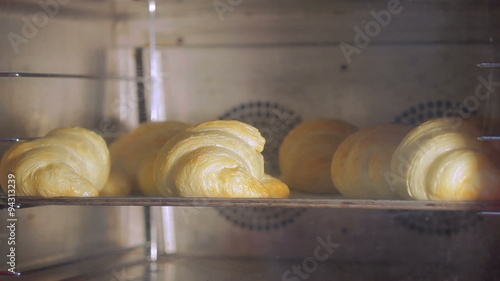 Croissants baking on industrial oven, time-lapse 