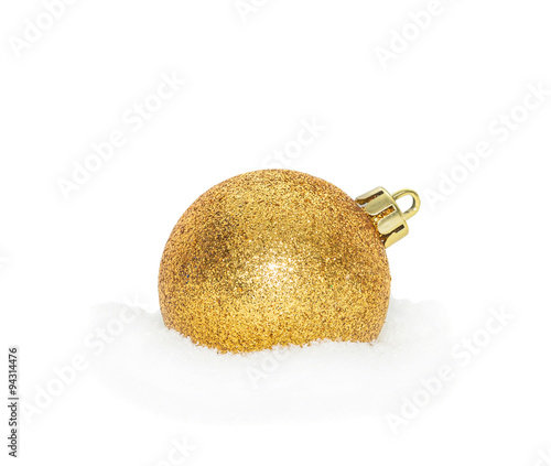 Gold Christmas New Year bauble, ball lying on the white snow, snowy, isolated on a white background