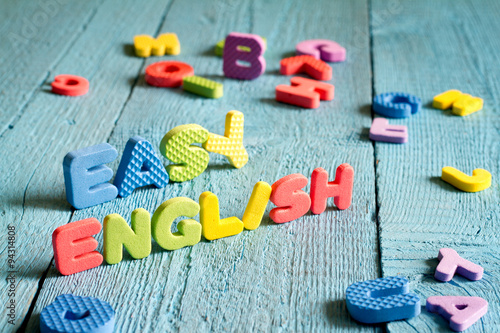 English is easy to learning concept with letters on blue boards
 photo