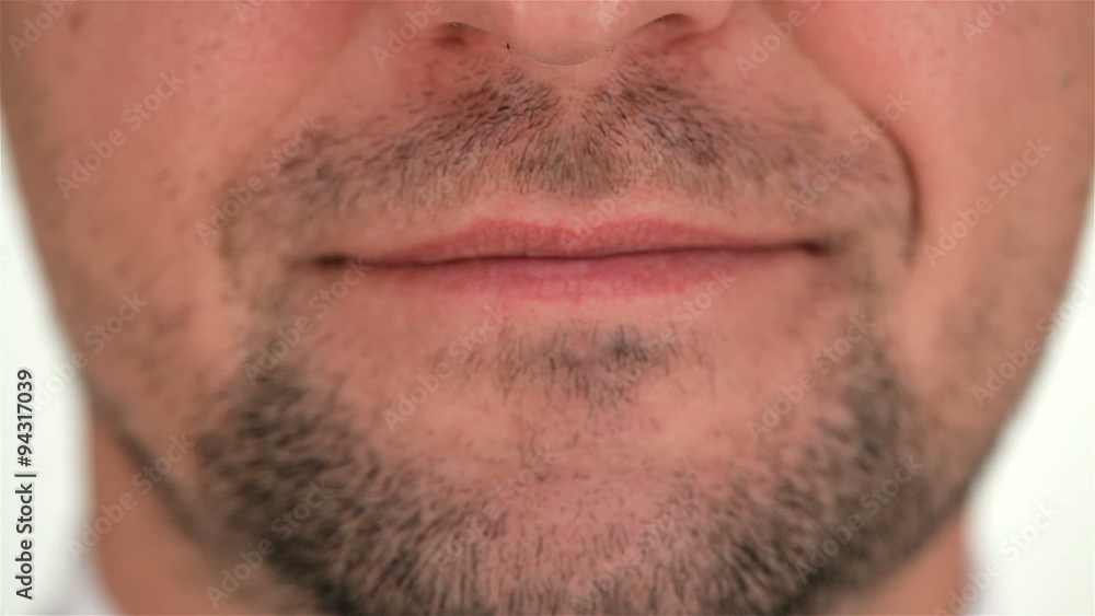 Part of the human unshaven face and smile Part of the human unshaven face and smile