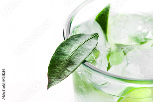 Fresh cocktail with lime slices isolated on white background