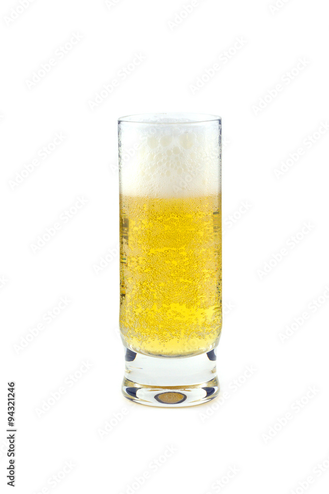 High transparent glass full of cold beer isolated on white closeup. Vertical view High transparent glass full of cold beer isolated on white closeup. Vertical view