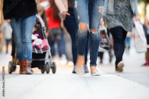 Woman walking in sidewalk crowd