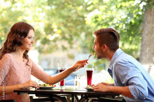 happy couple eating at terrace