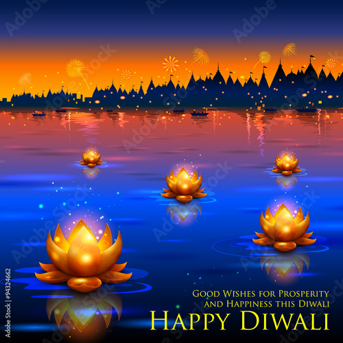 Golden lotus shaped diya floating on river in Diwali background