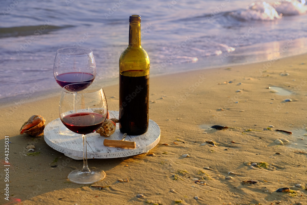 Wine bottle and glasses on the seashore Wine bottle and glasses on the seashore