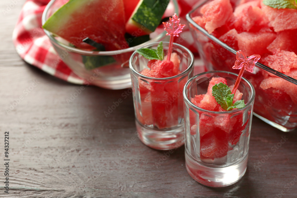 Cold watermelon desserts and drinks in glasses, on wooden table background Cold watermelon desserts and drinks in glasses, on wooden table background