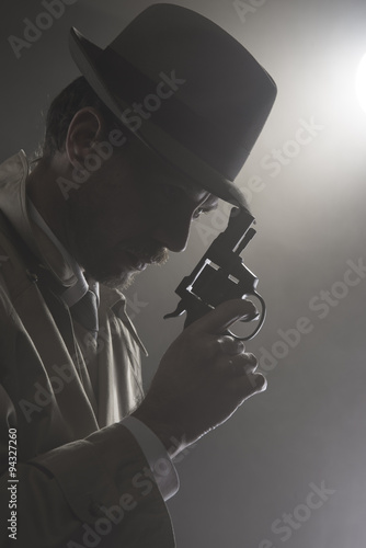 Film noir: detective in the dark with a gun photo