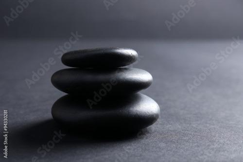 Balanced pebbles on dark background