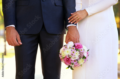 Bride and groom holding wedding bouquet