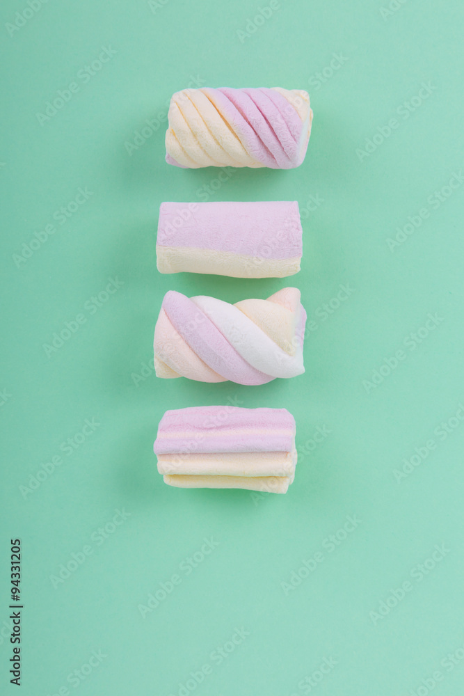 marshmallow candies in different colors on the background of turquoise. top view. entertainment for children in celebration. marshmallow candies in different colors on the background of turquoise. top view. entertainment for children in celebration.