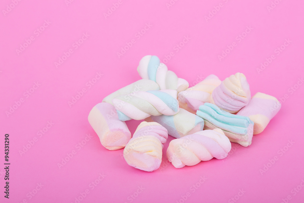 marshmallow candies of different colors in the glass on the background of pink. top view. entertainment for children in celebration. marshmallow candies of different colors in the glass on the background of pink. top view. entertainment for children in celebration.