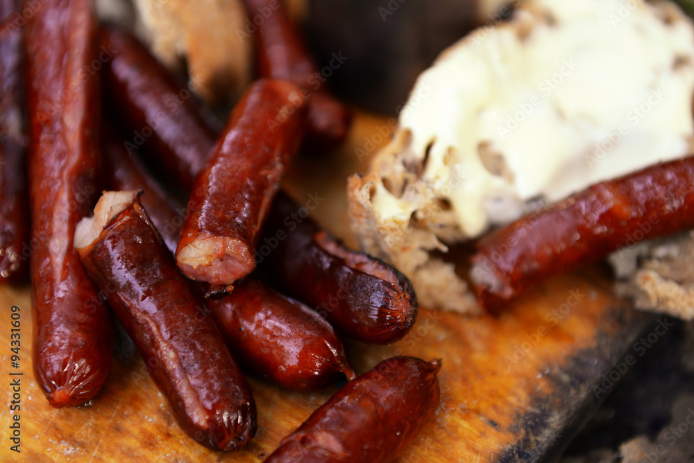 Grilled sausages on cutting board in the wood Grilled sausages on cutting board in the wood