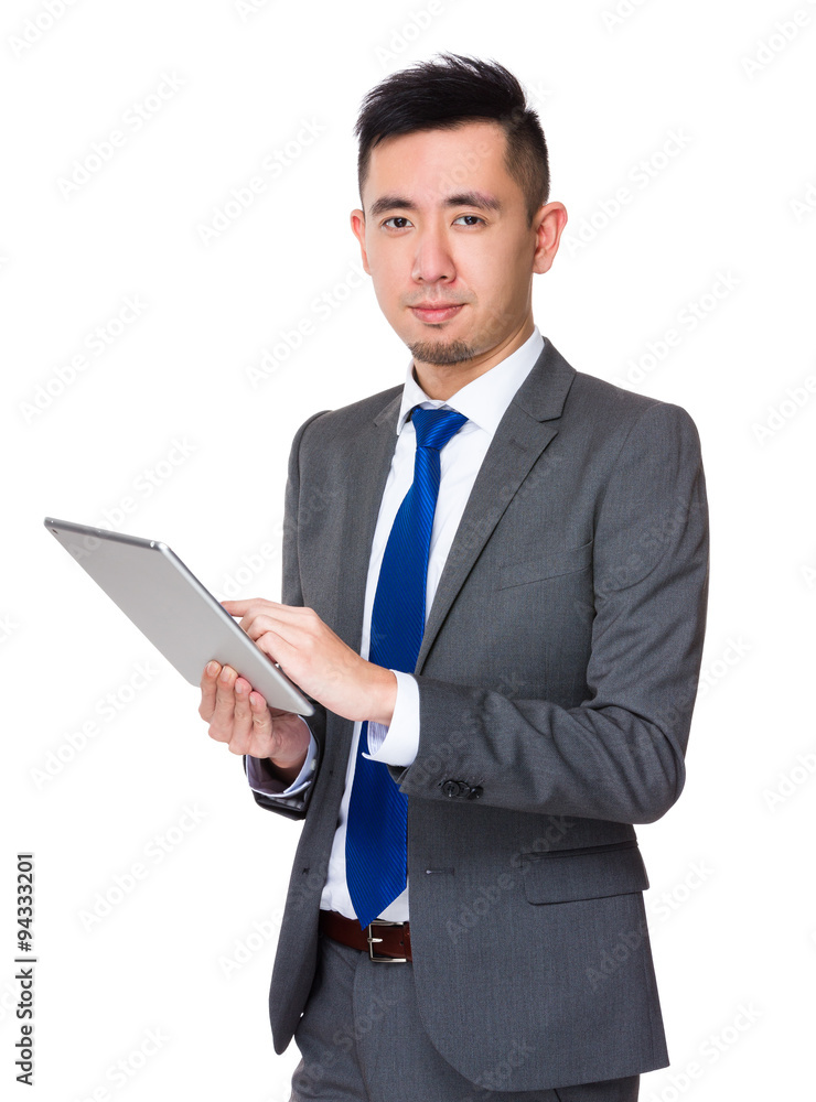 Young Asian Businessman use of the digital tablet pc