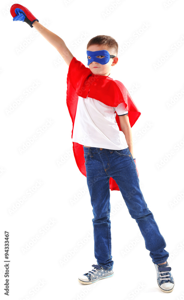 Boy dressed as superhero with boxing gloves poses in studio  isolated on white background