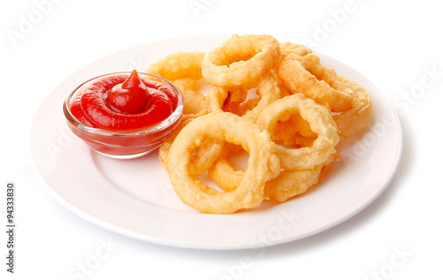 Chips rings with sauce on plate isolated on white