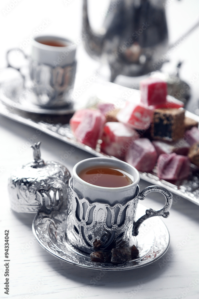 Antique tea-set with Turkish delight on table close-up Antique tea-set with Turkish delight on table close-up