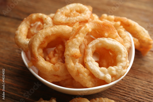 Chips rings in bowl on wooden background © Africa Studio