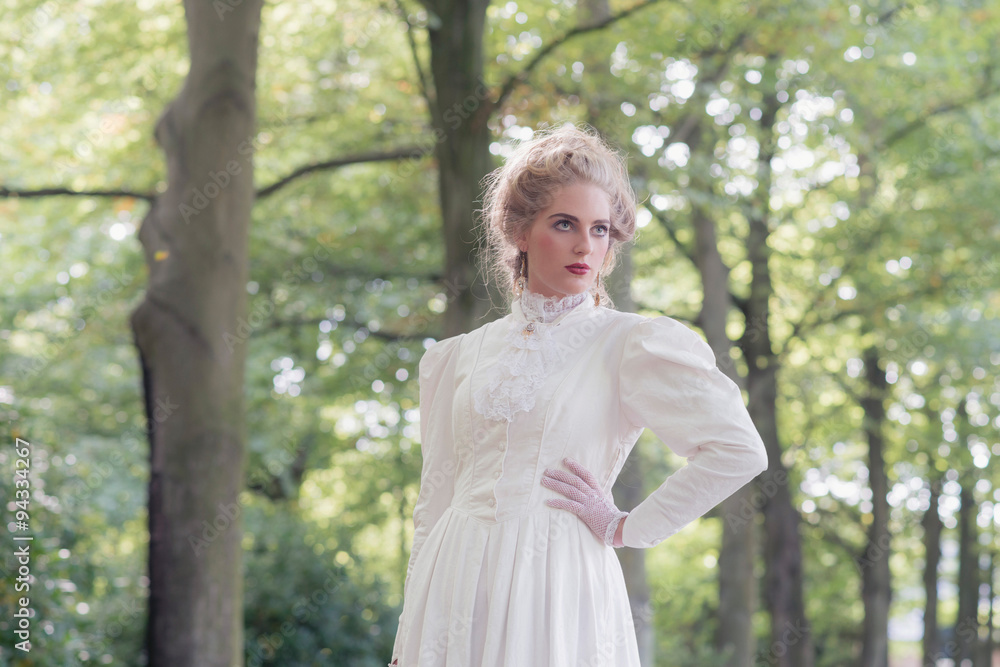 Retro victorian woman in front of tree row. Retro victorian woman in front of tree row.