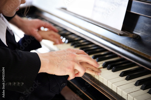 Close up of musician man and girl hands piano playing